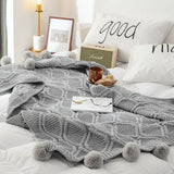 Plaid pompon gris